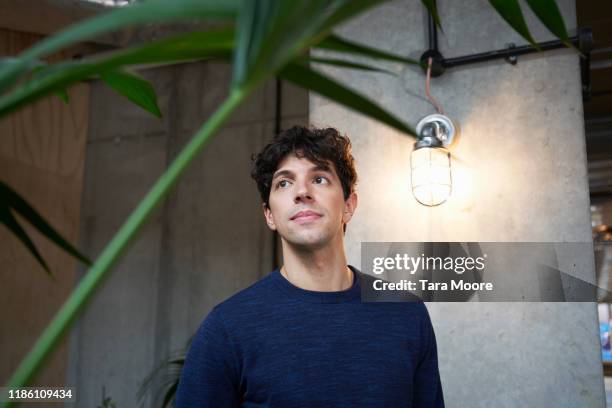 portrait of young man in office - candid photos et images de collection