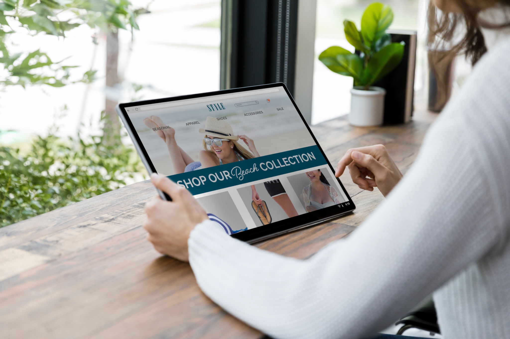 Unrecognizable woman searches site on tablet for summer wear Unrecognizable woman searches site on tablet for summer wear