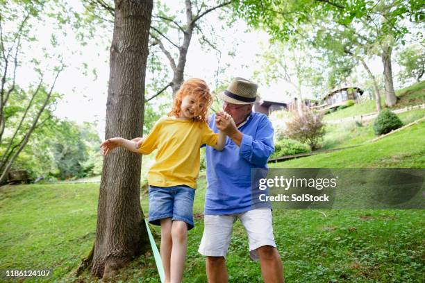 a caring grandfather - rope walking stock pictures, royalty-free photos & images