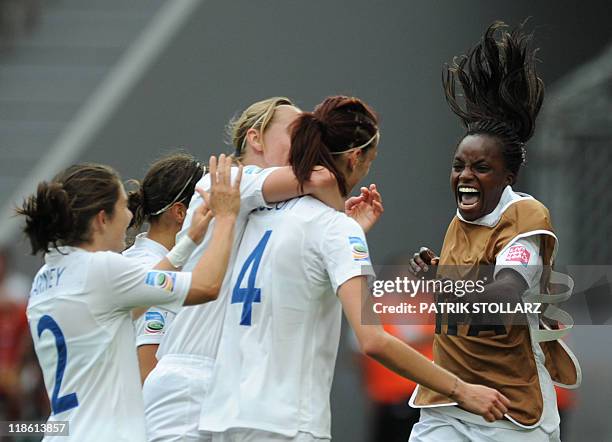 England's midfielder Jill Scott is congratulated by England's forward Eniola Aluko and other teammates after scoring the 1-0 during the quarter-final...