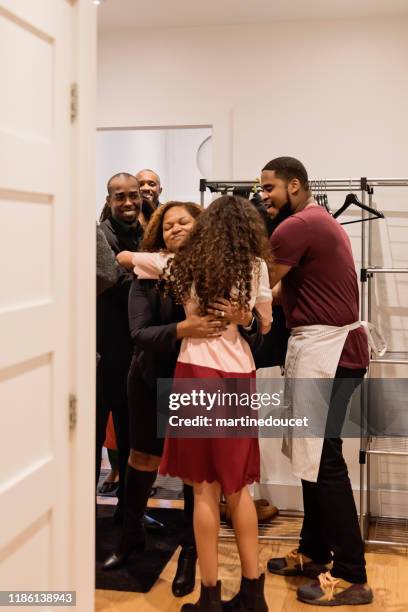 family welcoming guest for thanksgiving dinner. - thanksgiving arrival stock pictures, royalty-free photos & images