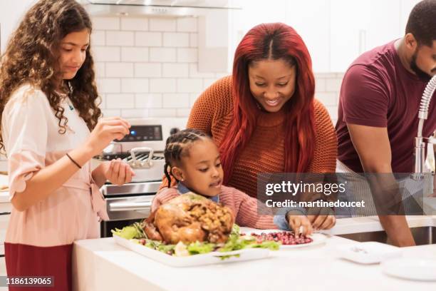 family preparing thanksgiving dinner. - haitian ethnicity stock pictures, royalty-free photos & images