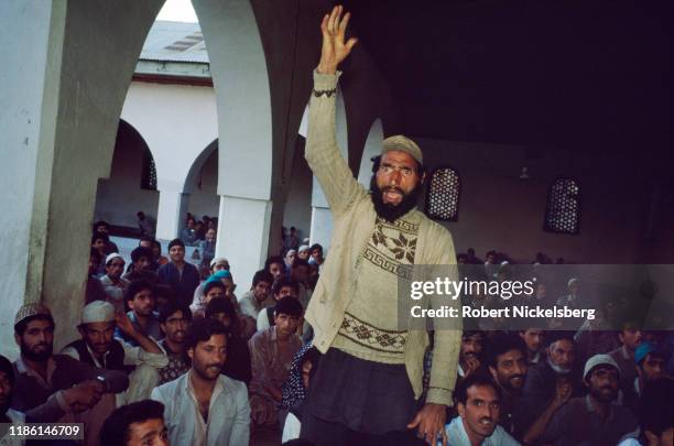 An unidentified man raises his arm as he emphatically speaks during a discussion among moderate and militant Kashmiri separatists at an unspecified...