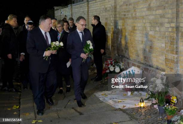 Secretary of State Mike Pompeo and German Foreign Minister Heiko Maas lay flowers outside a synagogue that was the site of an attempted right-wing...