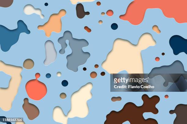 colorful ink droplets cut out from paper surface - papierhandwerk stock-fotos und bilder