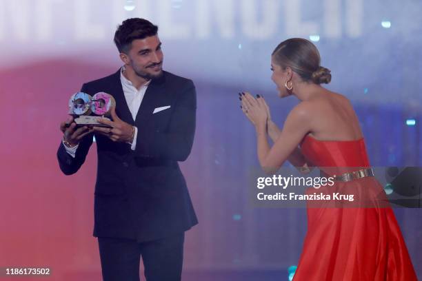 Laudator Victoria Swarovski congratulates award winner Mariano Di Vaio on stage during the GQ Men of the Year Award show at Komische Oper on November...