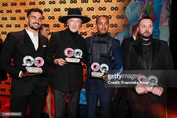 Award winners Mariano Di Vaio, Marius Mueller-Westernhagen, Lewis Hamilton and Kim Jones on stage during the GQ Men of the Year Award show at...