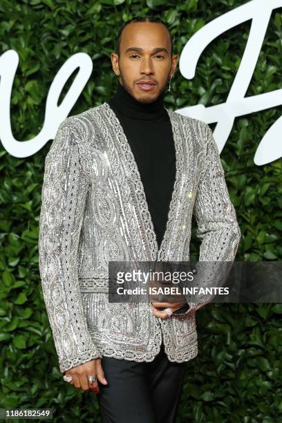 British Formula One driver Lewis Hamilton poses on the red carpet upon arrival at The Fashion Awards 2019 in London on December 2, 2019. - The...