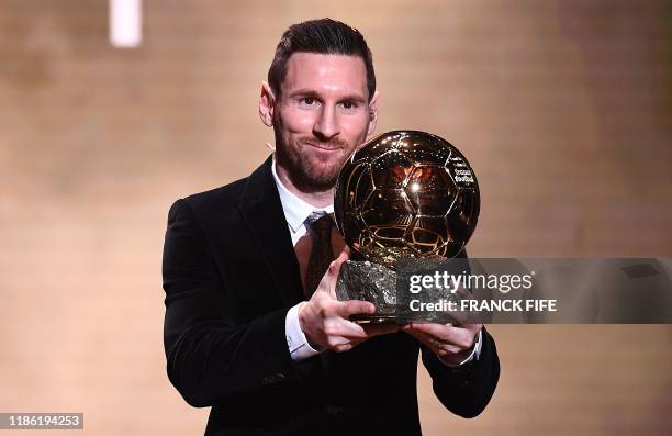 Barcelona's Argentinian forward Lionel Messi reacts after winning the Ballon d'Or France Football 2019 trophy at the Chatelet Theatre in Paris on...