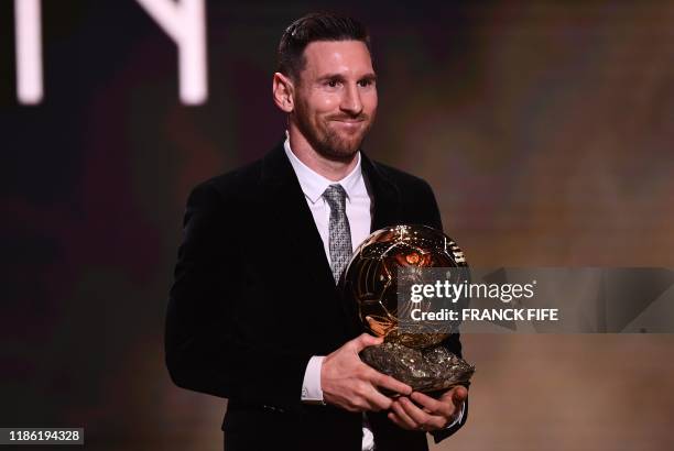 Barcelona's Argentinian forward Lionel Messi reacts after winning the Ballon d'Or France Football 2019 trophy at the Chatelet Theatre in Paris on...