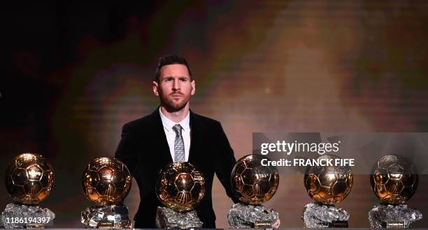 Barcelona's Argentinian forward Lionel Messi reacts after winning the Ballon d'Or France Football 2019 trophy at the Chatelet Theatre in Paris on...