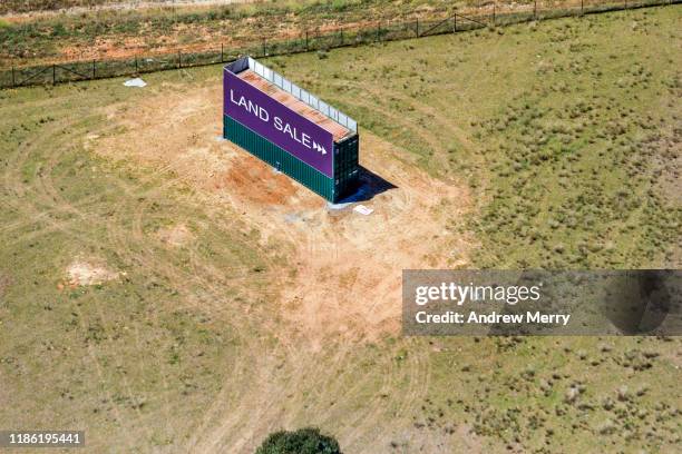 land sale sign, billboard by highway roadside at the edge of city, urban sprawl in sydney, australia, aerial photography - deforestation australia stock pictures, royalty-free photos & images