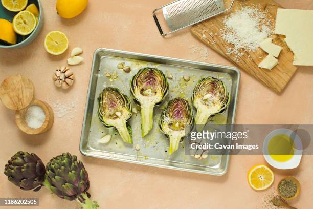 high angle view of artichokes served in tray on table - alcachofra imagens e fotografias de stock