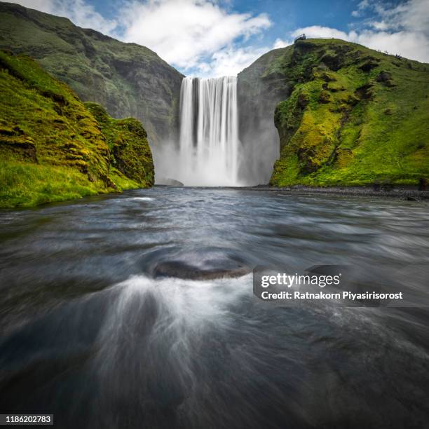 amazing nature scene of skogafoss waterfall in iceland. - skogafoss waterfall stock pictures, royalty-free photos & images