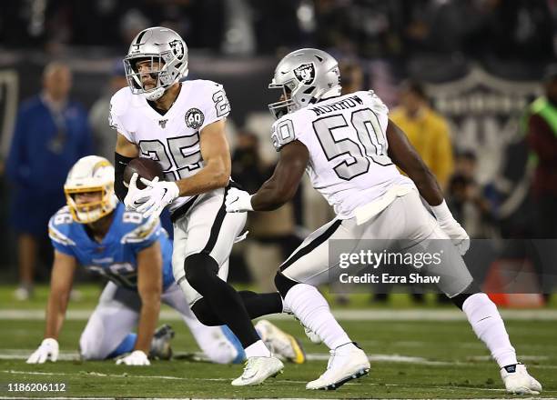 Free safety Erik Harris of the Oakland Raiders makes an interception to return a 56 yard touchdown in the first quarter over the Los Angeles Chargers...