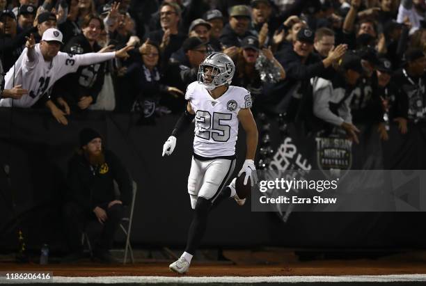 Free safety Erik Harris of the Oakland Raiders and fans celebrate an interception return for a touchdown in the first quarter over the Los Angeles...