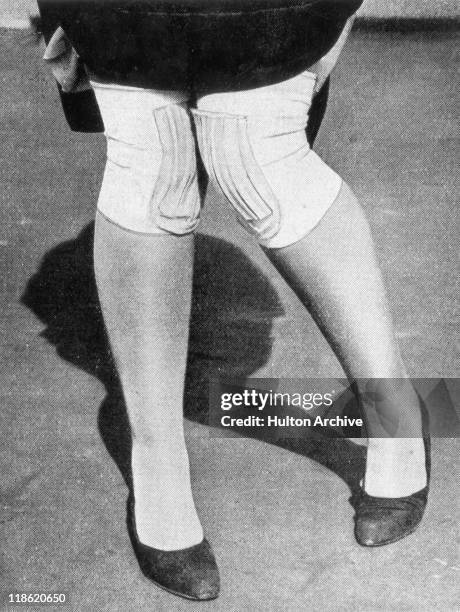 Close-up of the legs of a woman dancing the Charleston, wearing protecive covers on her kness to guard against any bruising while performing the...