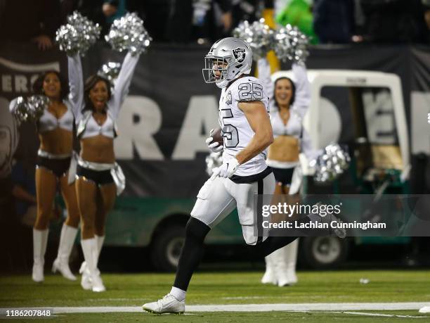 Erik Harris of the Oakland Raiders runs to the end zone to score a touchdown after intercepting a pass by Philip Rivers of the Los Angeles Chargers...