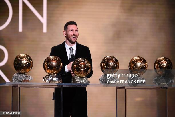 Barcelona's Argentinian forward Lionel Messi reacts after winning the Ballon d'Or France Football 2019 trophy at the Chatelet Theatre in Paris on...