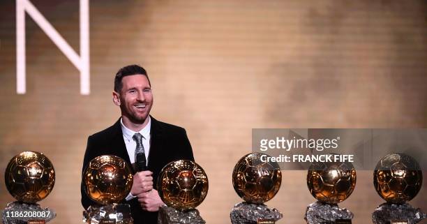 Barcelona's Argentinian forward Lionel Messi reacts after winning the Ballon d'Or France Football 2019 trophy at the Chatelet Theatre in Paris on...