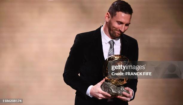 Barcelona's Argentinian forward Lionel Messi reacts after winning the Ballon d'Or France Football 2019 trophy at the Chatelet Theatre in Paris on...