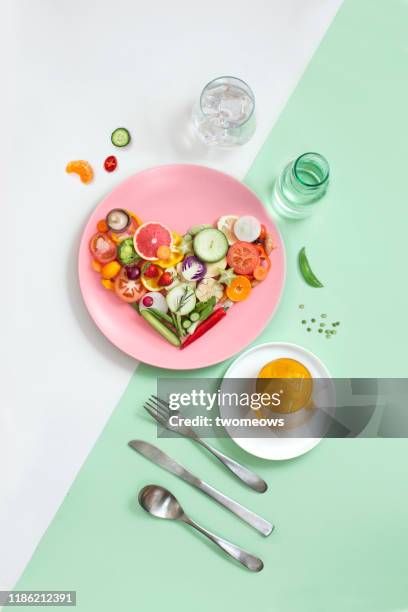 colourful vegan food eating conceptual still life. - heart healthy lifestyle stock pictures, royalty-free photos & images