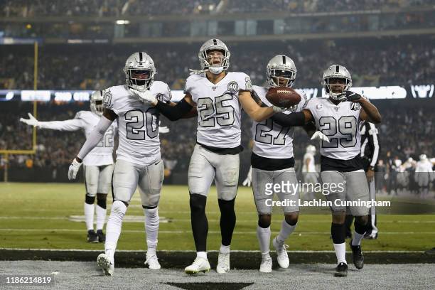 Erik Harris of the Oakland Raiders reacts with teammates after intercepting a pass by Philip Rivers of the Los Angeles Chargers in the second quarter...