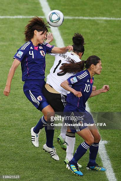 Celia Okoyino Da Mbabi of Germany heads for the ball with Saki Kumagai and Homare Sawa of Japan during the FIFA Women's World Cup quarter finals...