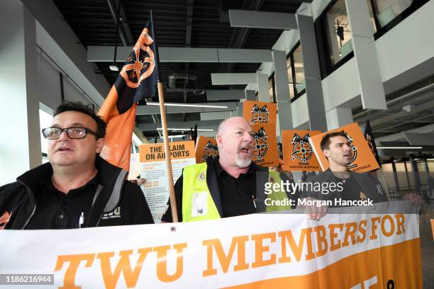Airport workers and union members march towards airport management at Melbourne Airport on November 08, 2019 in Various Cities, Australia. Baggage...