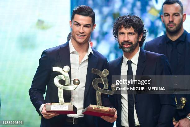 Juventus' Portuguese forward Cristiano Ronaldo poses with President of the Associazione Italiana Calciatori , Damiano Tommasi, after receiving the...