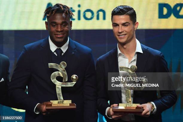 Atalanta's Colombian forward Duvan Zapata and Juventus' Portuguese forward Cristiano Ronaldo pose with their trophy of best forwards of the Italian...