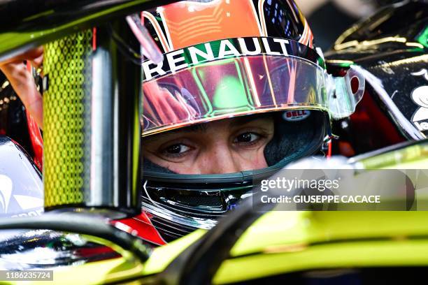 French Formula One driver Esteban Ocon sits in his car during a test day at the Yas Marina Circuit in Abu Dhabi, on December 3, 2019. - The...
