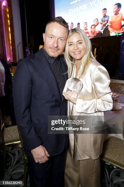 Jake Scott and honoree Sienna Miller attend the International Medical Corps Annual Awards Celebration at The Beverly Wilshire on November 07, 2019 in...