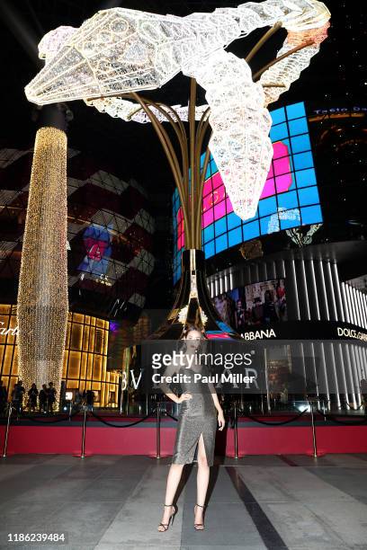 Min Pechaya poses for a photograph under the interactive Serpenti Necklace Light Structure during Bvlgari's Serpenti Light-up Ceremony at ION...