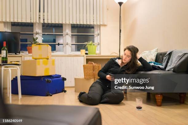 woman taking a break while moving house - korea apartment woman stock-fotos und bilder