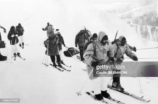 Caravan of rescuers descends the bodies of the two amateur mountaineers, Jean Vincendon, from Paris, and François Henry, from Brussels on March 1957....