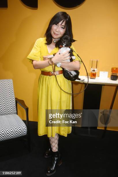 Actress Yubai Zhang and her dog Ocean attend the Red X BHV Marais Ephemere Boutique Launch Party on November 07, 2019 in Paris, France.