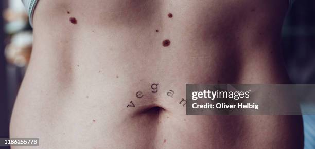 a woman's muscular belly - mole stockfoto's en -beelden