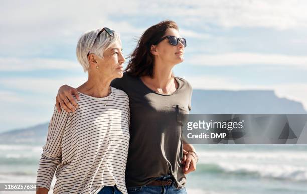 walks on the beach with mom is bliss - multi generation family thinking stock pictures, royalty-free photos & images