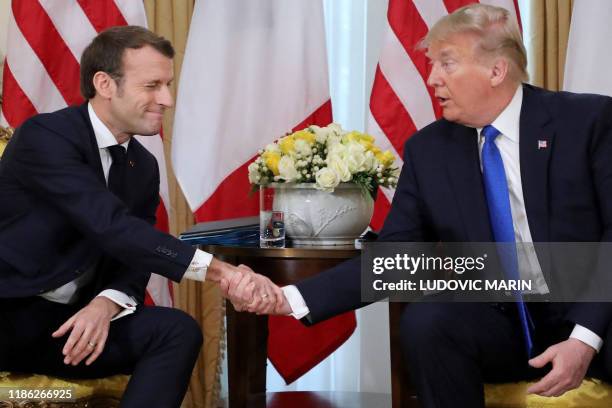 President Donald Trump and France's President Emmanuel Macron shake hands during their meeting at Winfield House, London on December 3, 2019. NATO...