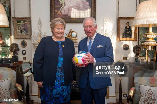 Prince Charles, Prince of Wales with a football that was presented by the Norwegian Prime Minister Erna Solberg at Clarence House on December 3, 2019...