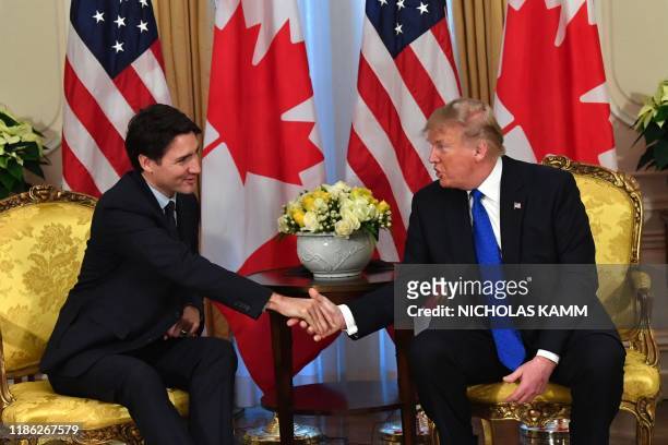 President Donald Trump shakes hands with Canada's Prime Minister Justin Trudeau during a meeting at Winfield House, London on December 3, 2019. -...