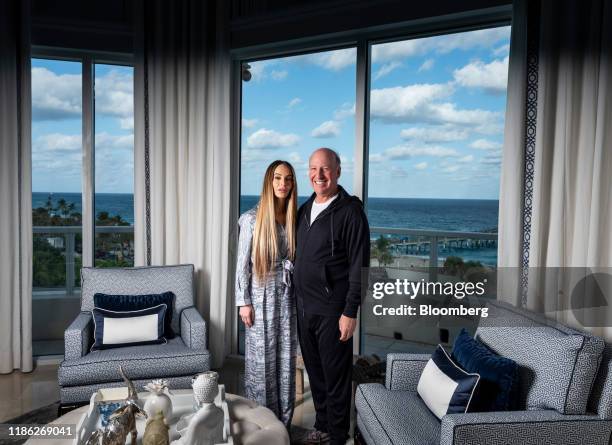 Steven Schonfeld, chief executive officer and founder of Schonfeld Group Holdings LLC, and his wife Brooke Schonfeld stand for a photograph in Palm...