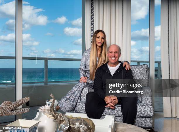 Steven Schonfeld, chief executive officer and founder of Schonfeld Group Holdings LLC, and his wife Brooke Schonfeld sit for a photograph in Palm...