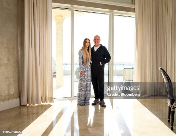 Steven Schonfeld, chief executive officer and founder of Schonfeld Group Holdings LLC, and his wife Brooke Schonfeld stand for a photograph in Palm...