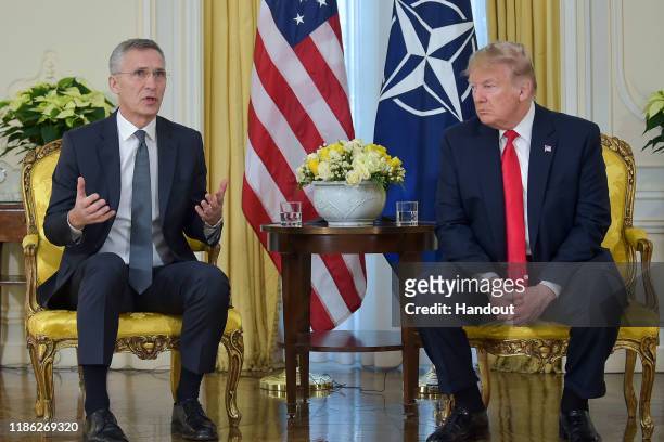 In this handout provided by NATO, Jens Stoltenberg, Secretary General of NATO speaks with U.S. President Donald Trump ahead of the NATO Leaders...