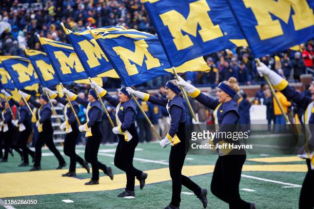 Michigan cheerleaders waving flags with team logo on field before game vs Ohio State at Michigan Stadium. Ann Arbor, MI CREDIT: Jeff Haynes