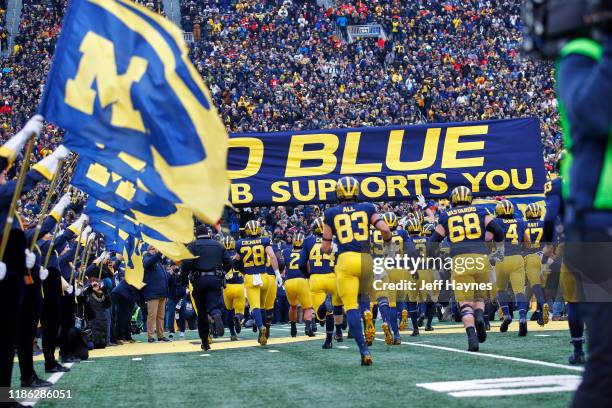 Rear view of Michigan players taking field before game vs Ohio State at Michigan Stadium. Ann Arbor, MI CREDIT: Jeff Haynes