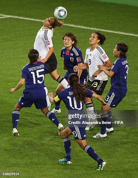 Babett Peter of Germany heads for the ball as her teammate Celia Okoyino Da Mbabi and Aya Sameshima, Mizuho Sakaguchi, Homare Sawa and Azusa...