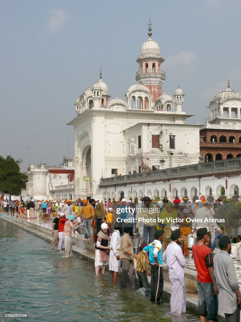 Sikh pilgrims during the washing of the marble ritual in Amritsar, Punjab, India